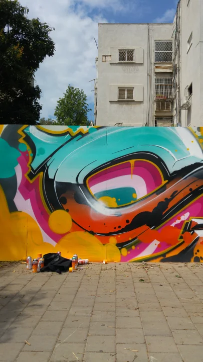 A detail of the colourful graffiti fence.