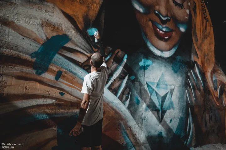Adding turquoise accents to the mural