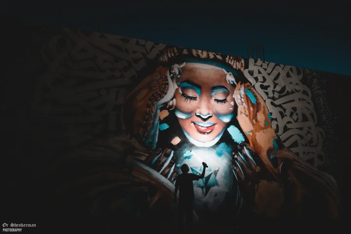 The mural illuminated at night